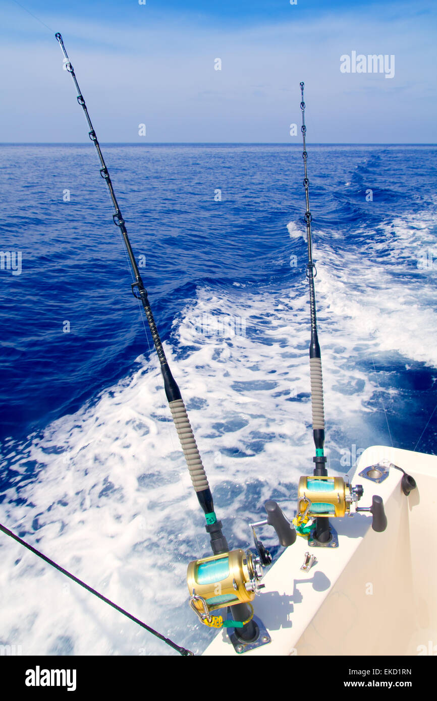 boat fishing trolling in deep blue sea Stock Photo - Alamy