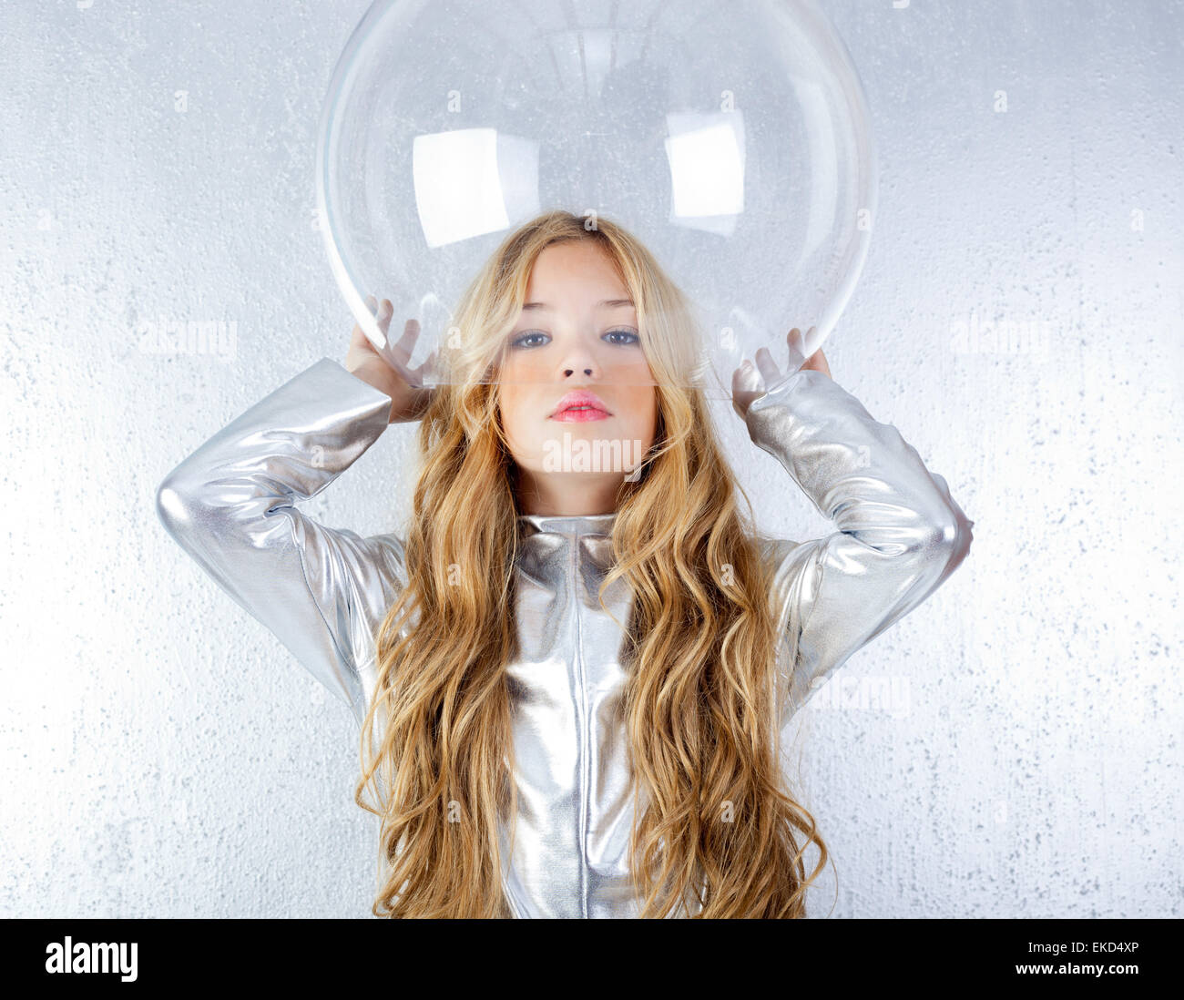 Astronaut girl with silver uniform and glass helmet Stock Photo - Alamy