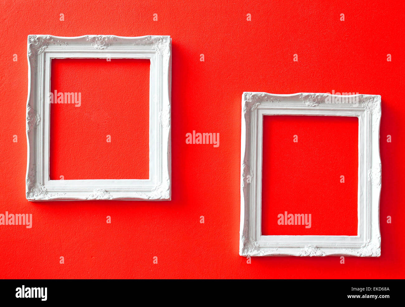 Two white vintage frames on red wall Stock Photo