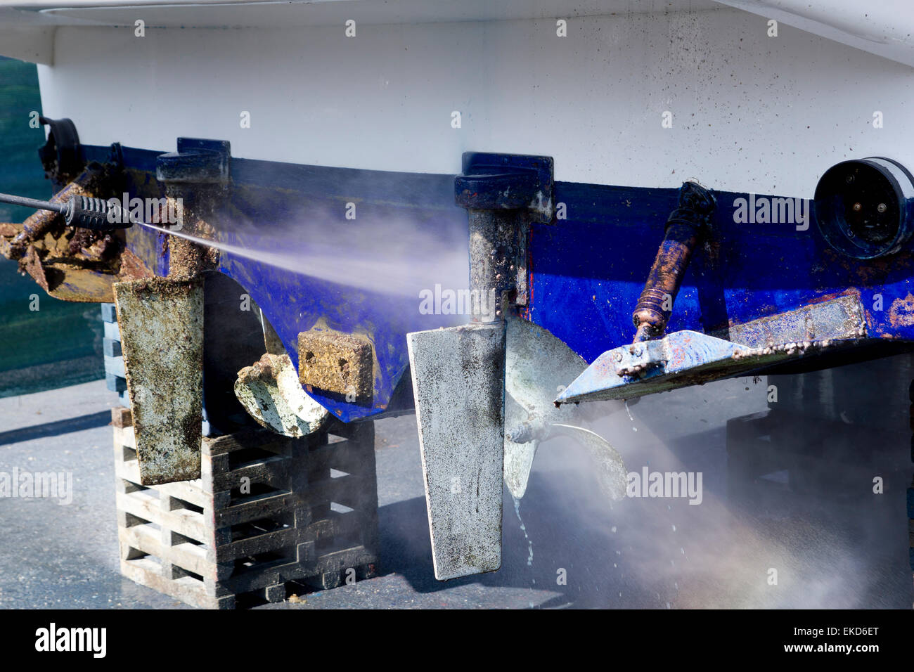 blue boat hull cleaning pressure washer barnacles Stock Photo Alamy