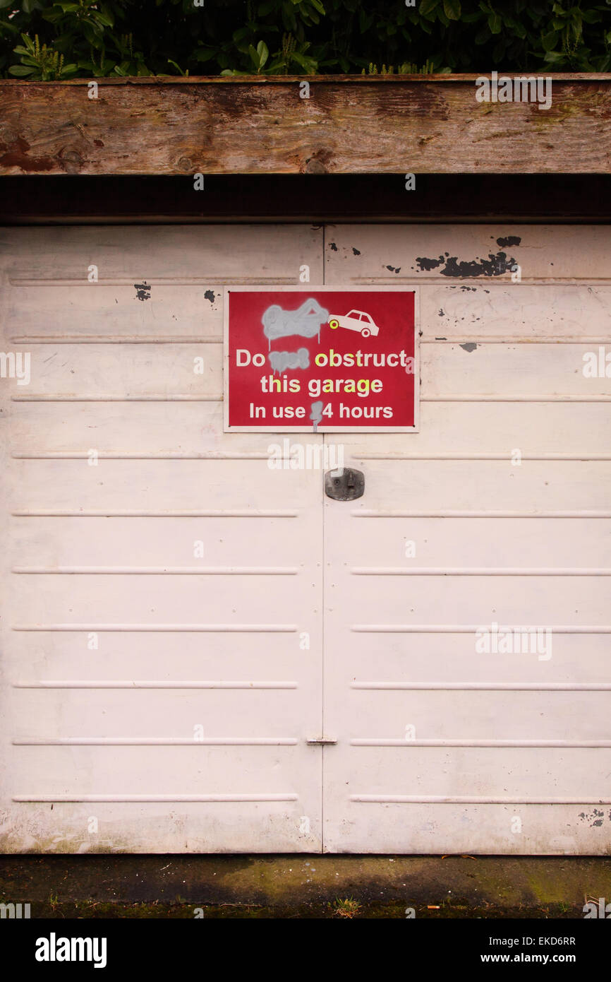 Do Not Obstruct This Garage in use 24 hours sing on a private garage in Bristol England UK Stock Photo