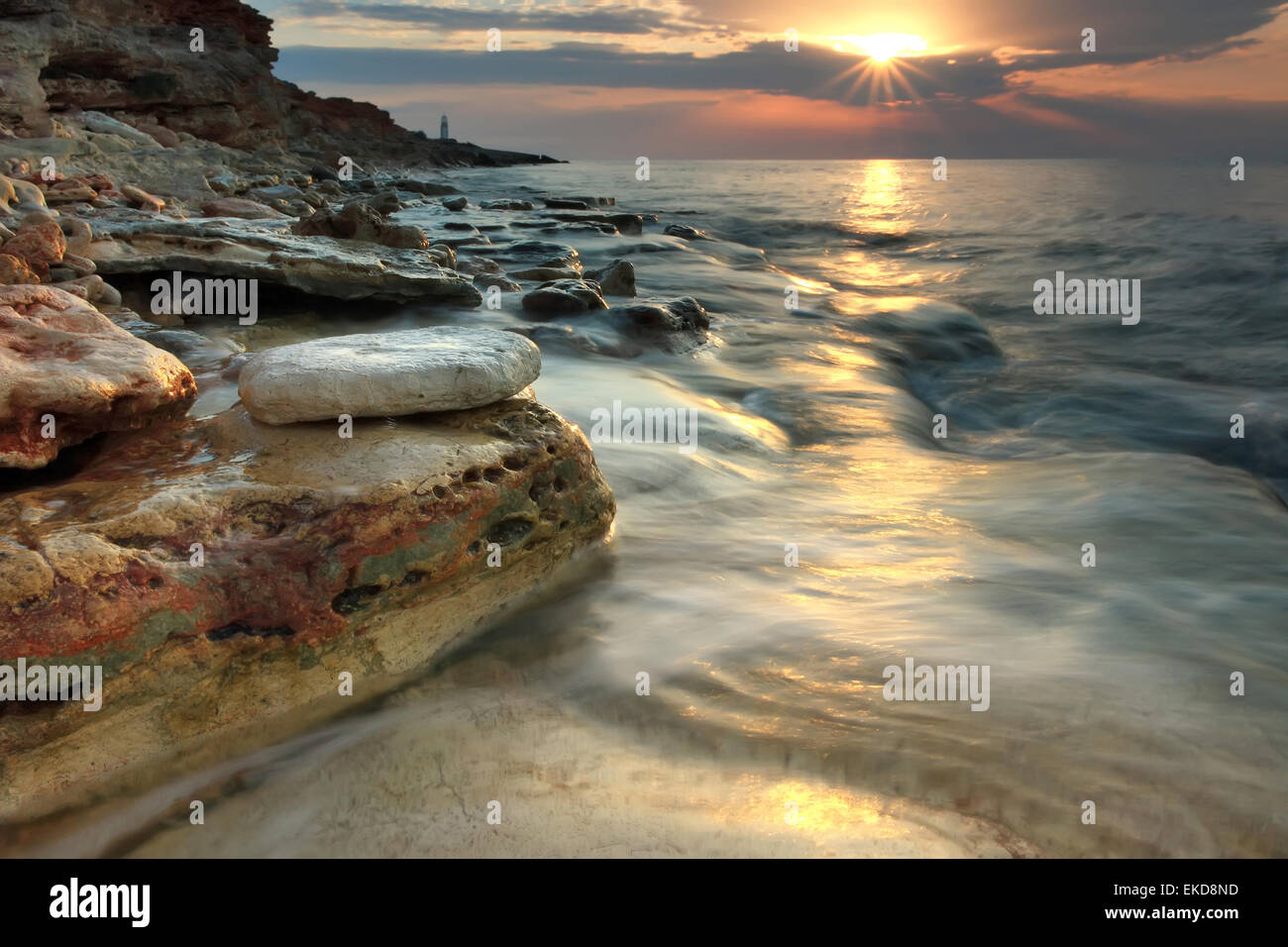 Beautiful rocky sea beach at the sunset Stock Photo - Alamy