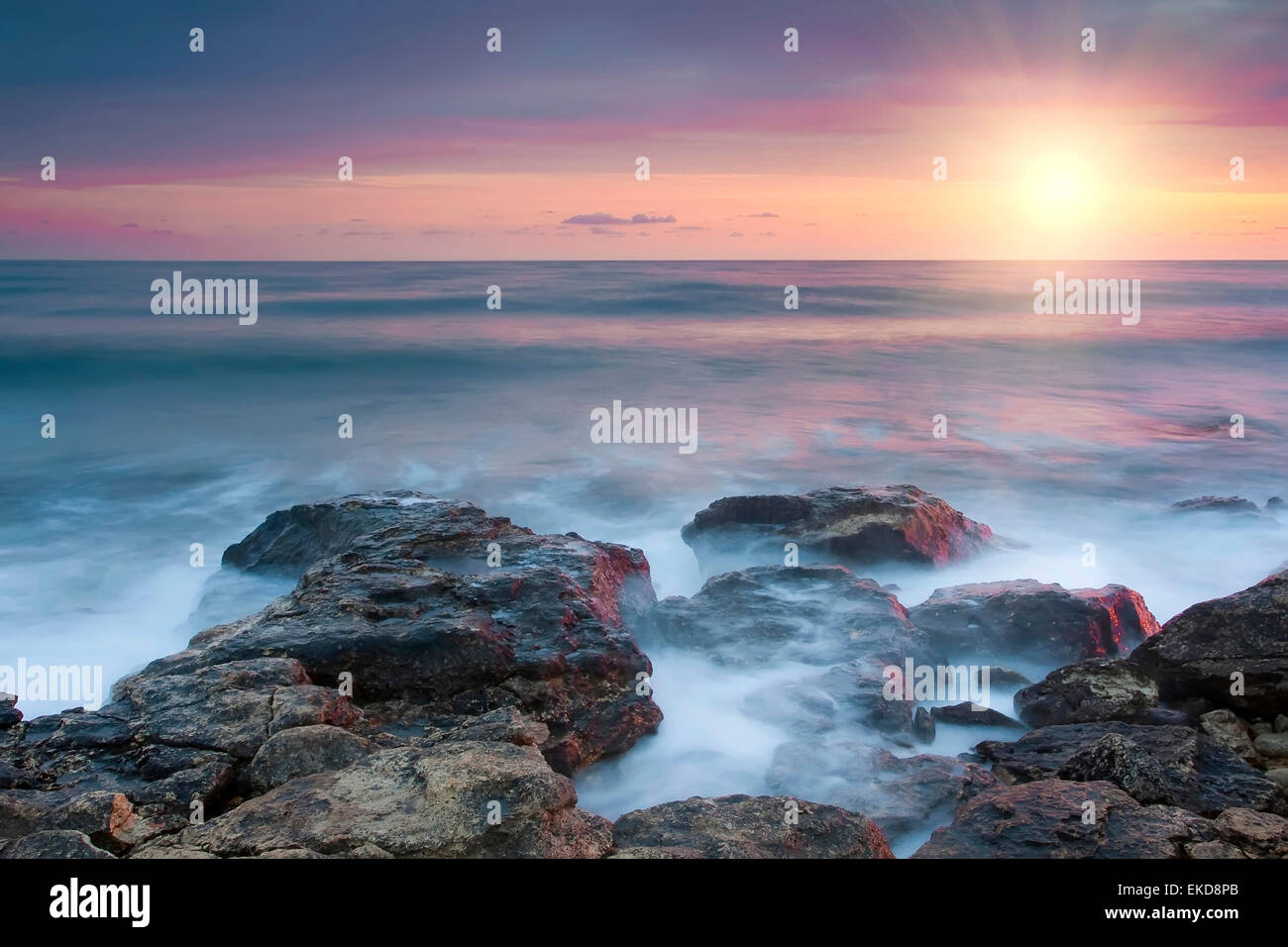 Beautiful rocky sea beach at the sunset Stock Photo - Alamy