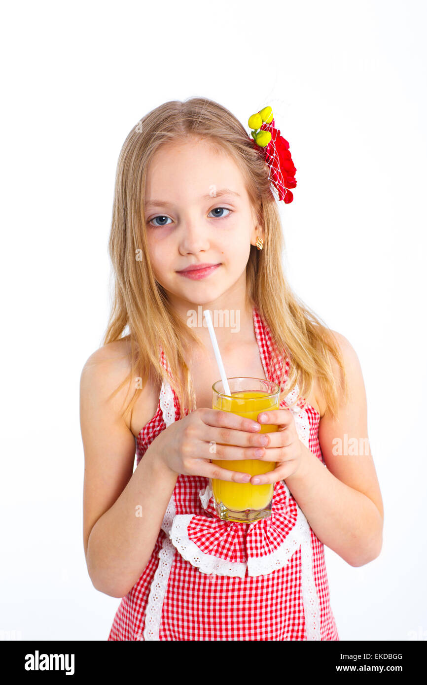 Portrait of little girl drinking orange juice Stock Photo - Alamy