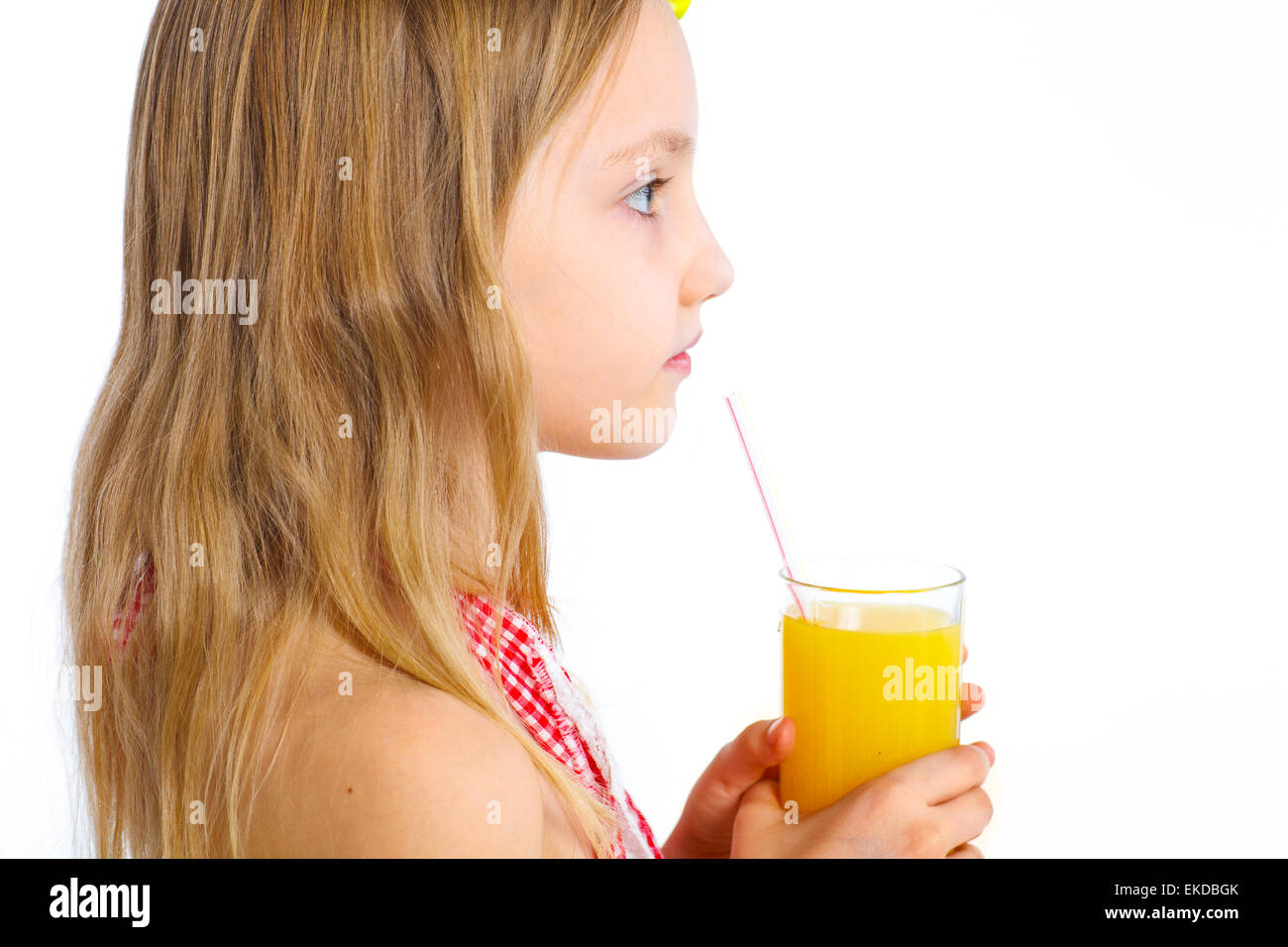 Portrait of little girl drinking orange juice Stock Photo - Alamy