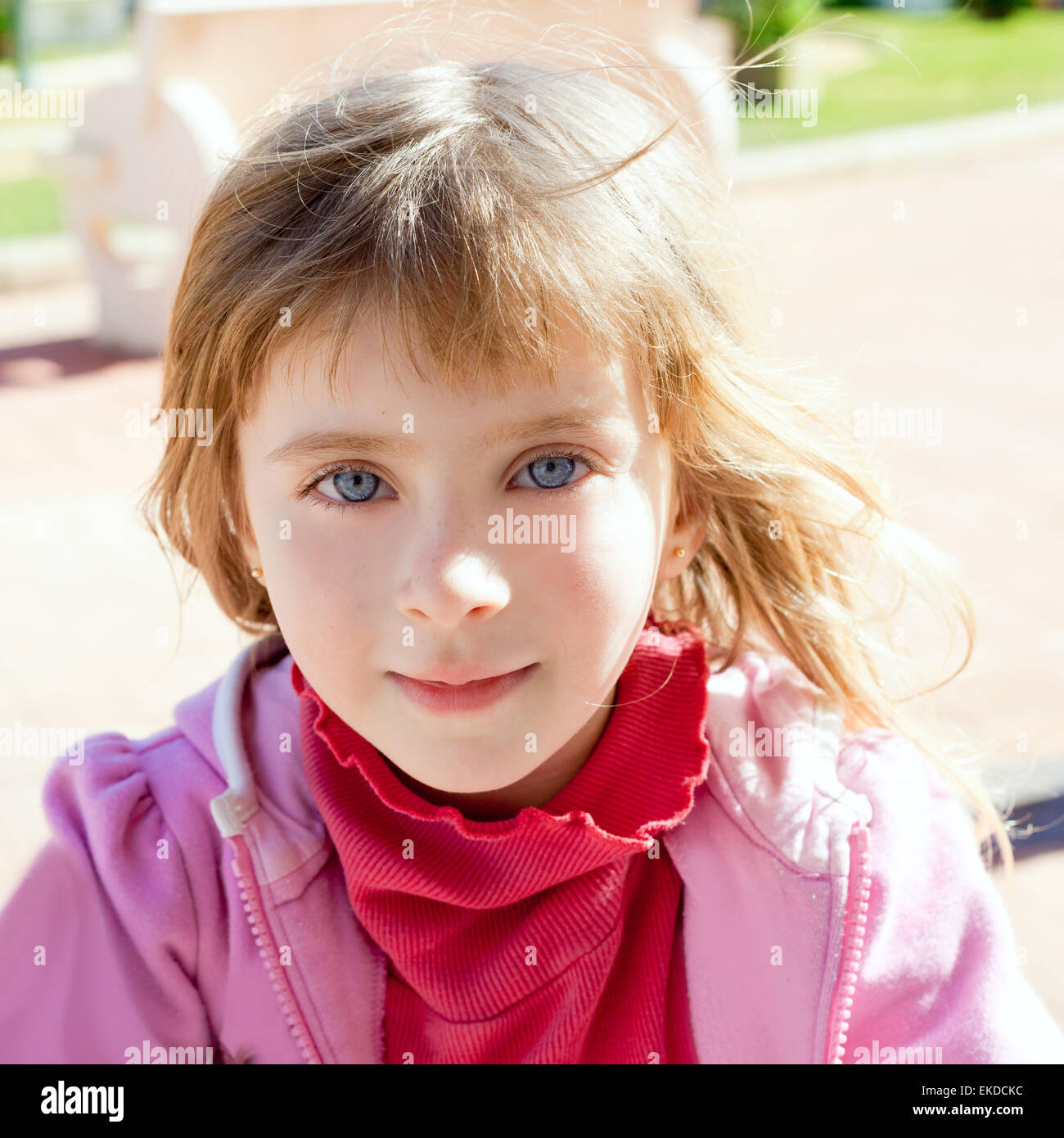 Blond little girl blue eyes portrait in pink Stock Photo - Alamy