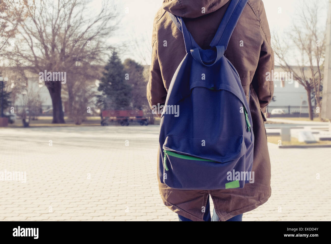 Rear view of hipster girl carring backpack on her back, copyspace Stock Photo