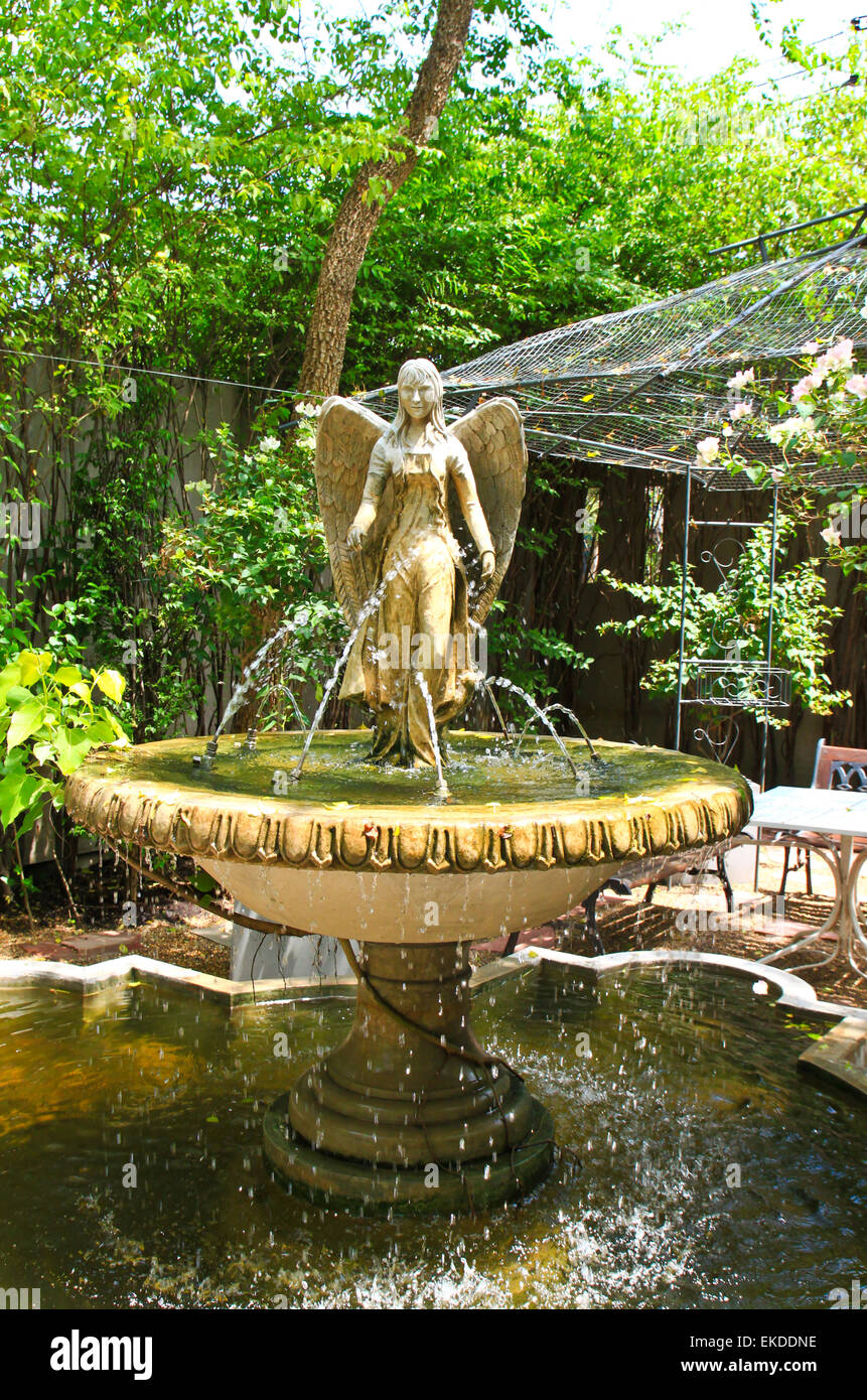 Angel sculpture fountain in the garden Stock Photo Alamy