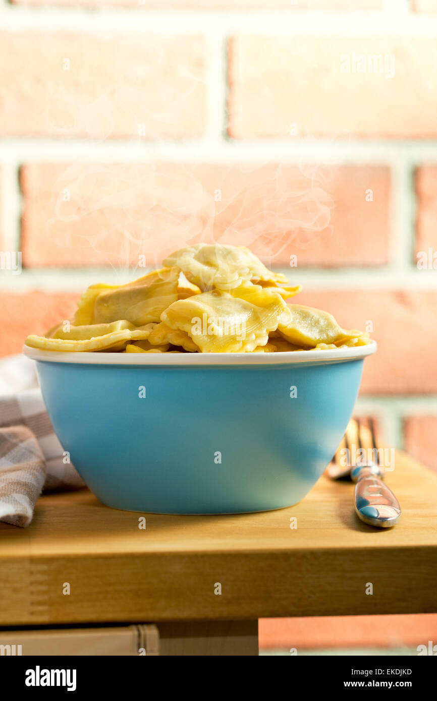 cooked ravioli in bowl on kitchen table Stock Photo - Alamy