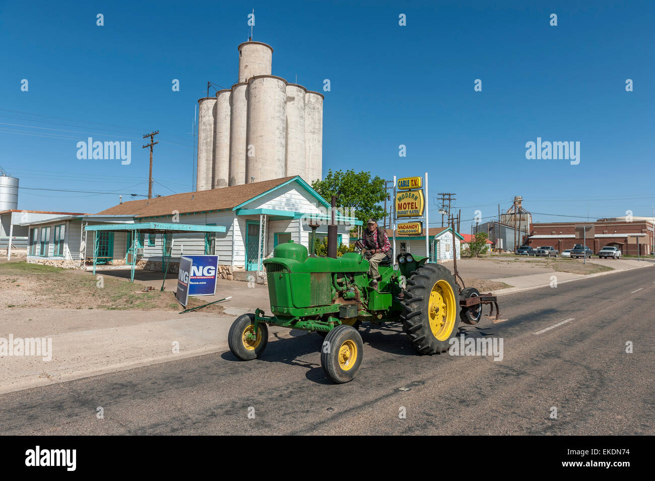 Old farmer driving a green tractor. Tulia. Texas panhandle. USA Stock