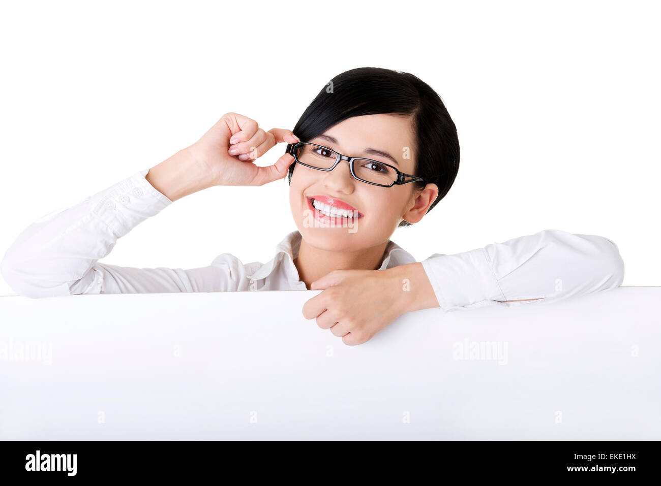 Smiling young business woman showing blank signboard Stock Photo - Alamy