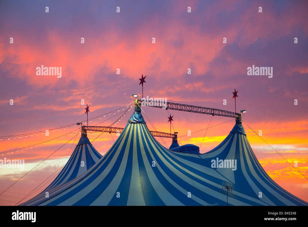 Circus tent in a dramatic sunset sky colorful Stock Photo - Alamy