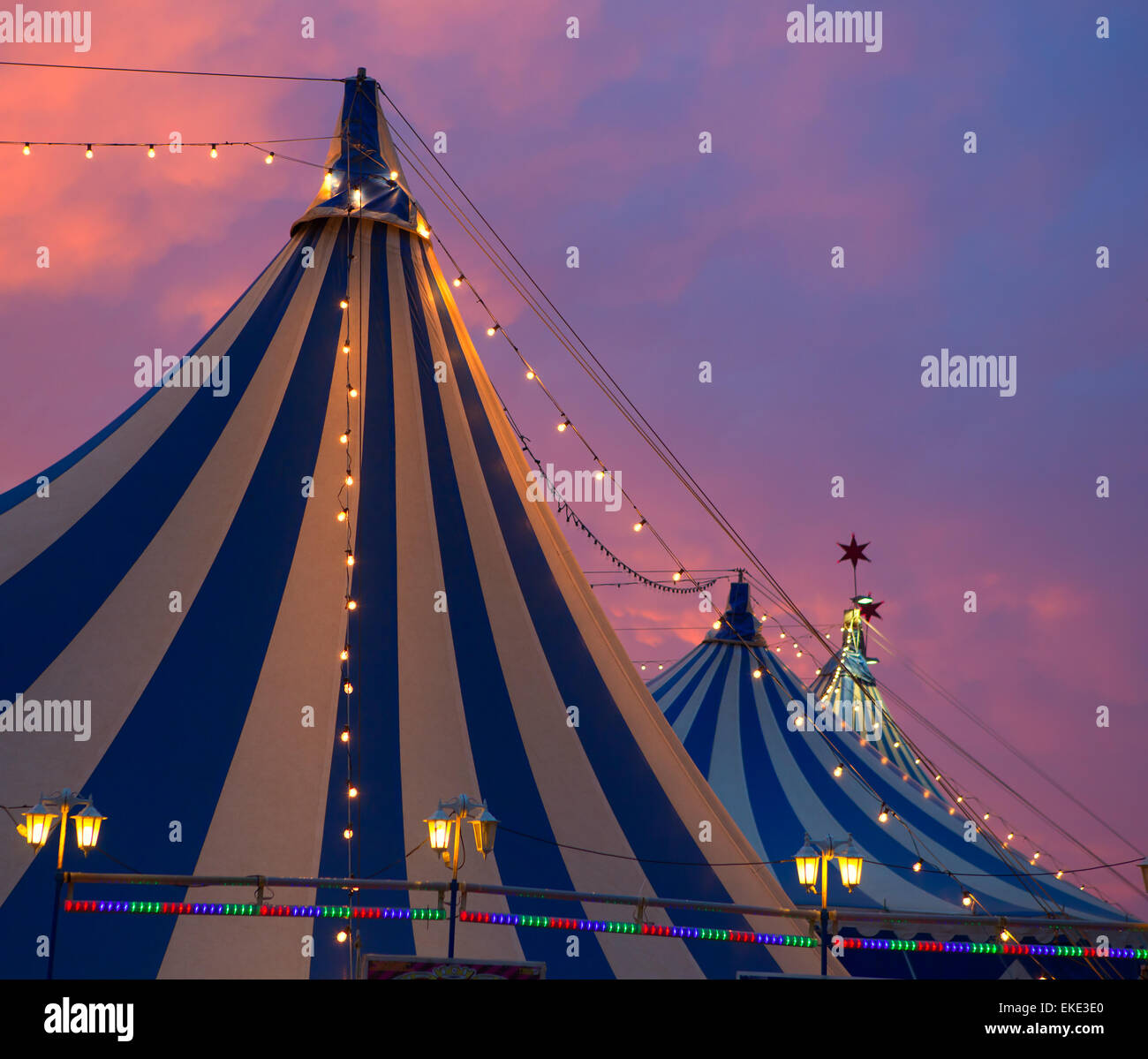 Circus tent in a dramatic sunset sky colorful Stock Photo - Alamy