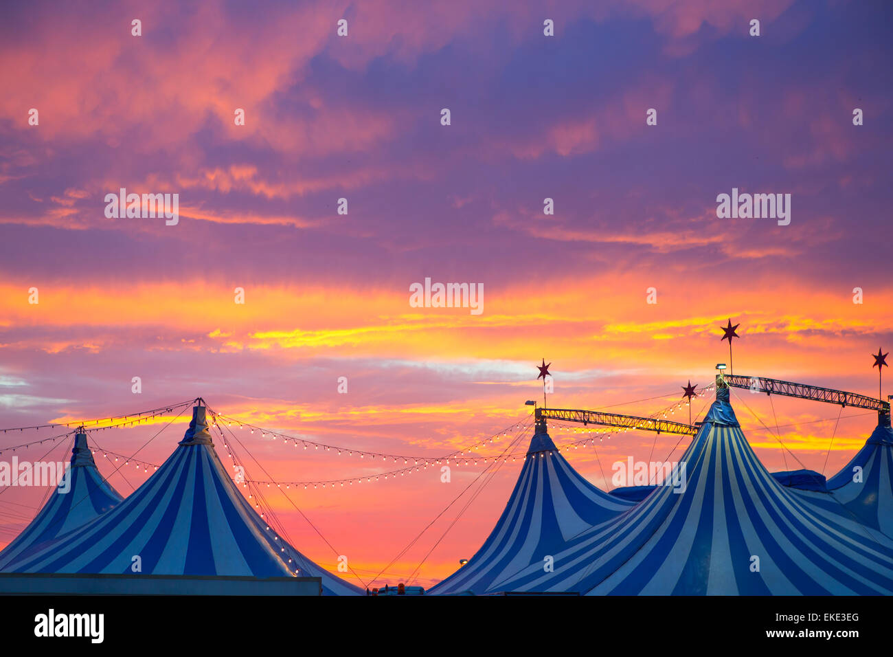 Circus tent in a dramatic sunset sky colorful Stock Photo - Alamy