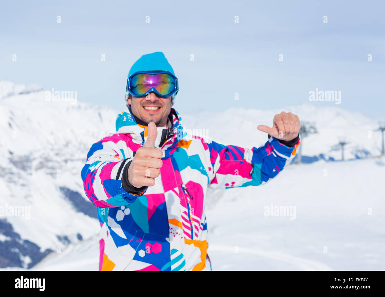 Young man with skis and a ski wear Stock Photo