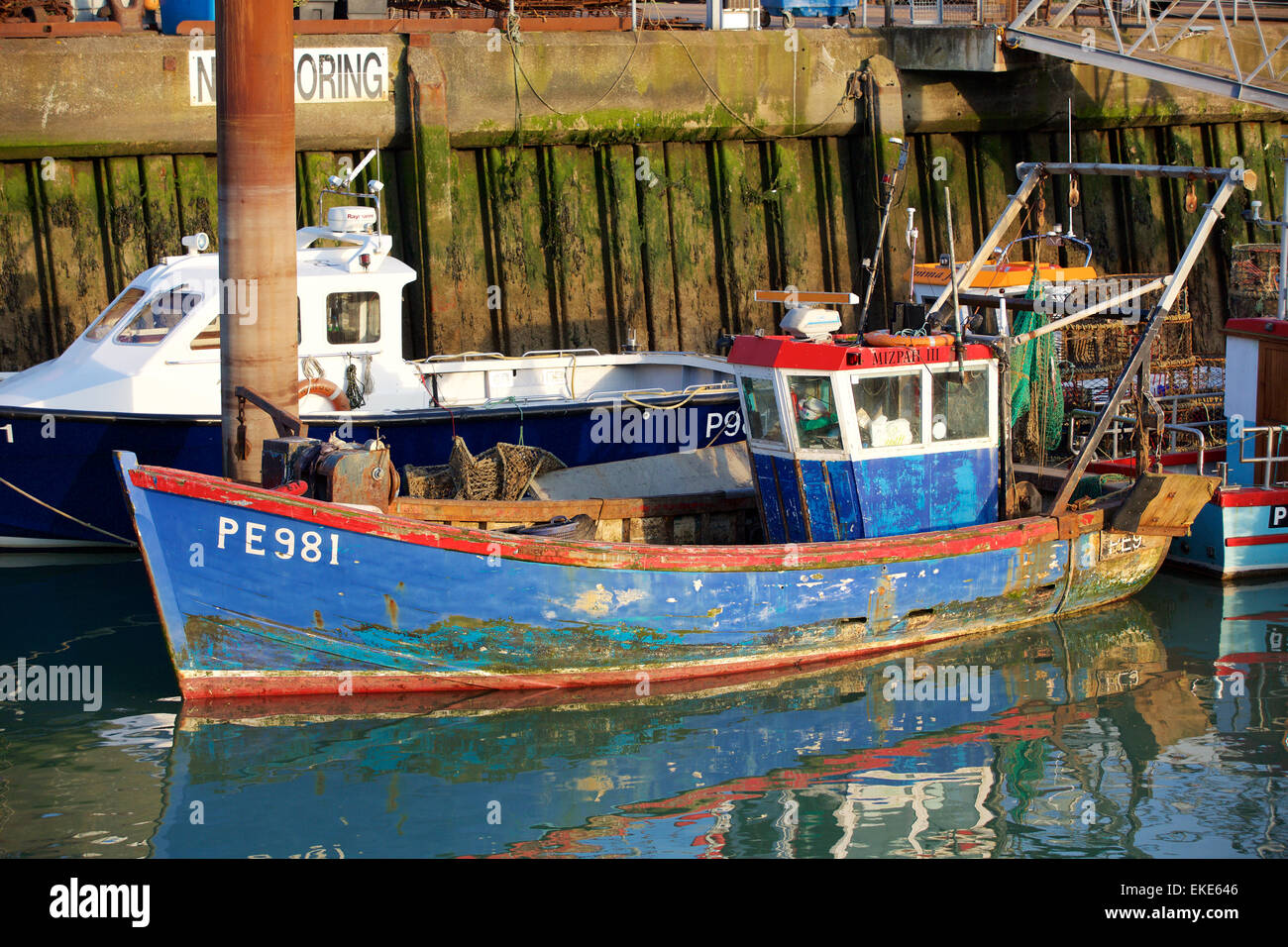 Old fishing boat moored in the harbor in the Camber docks old