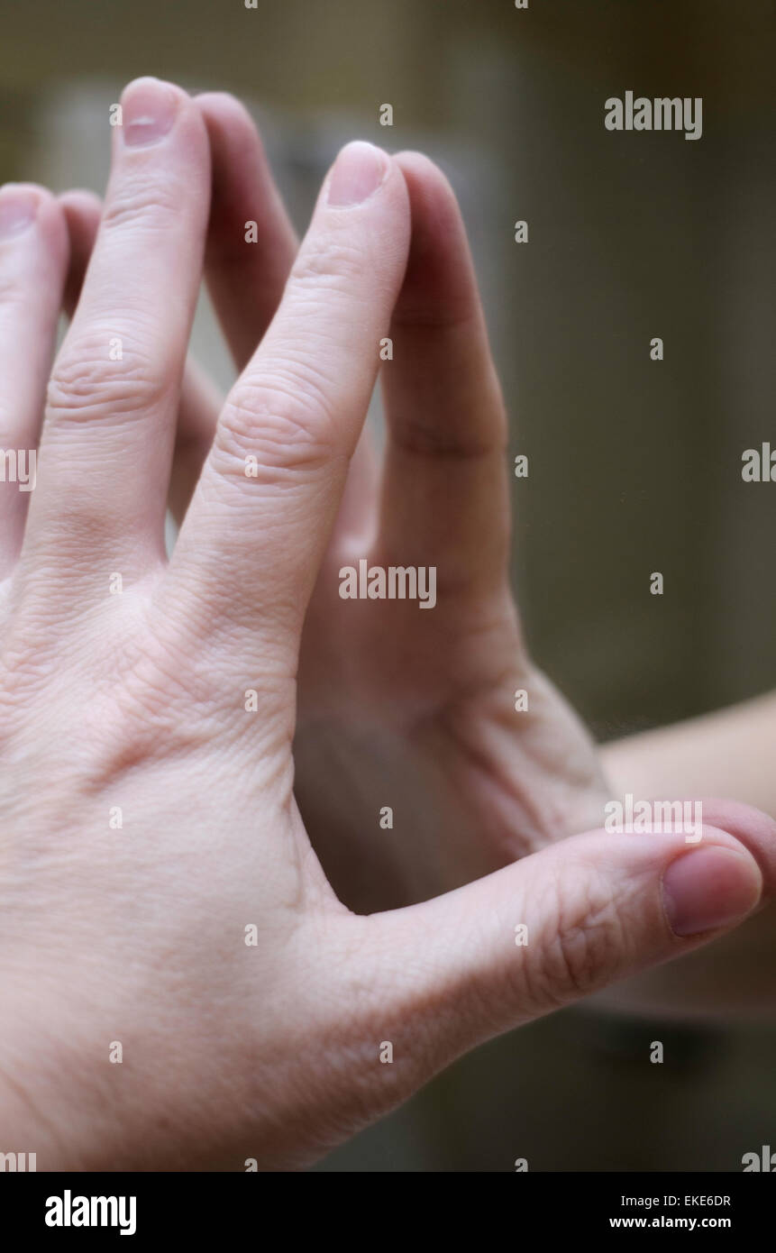 A woman's hand reflected in a mirror. Stock Photo