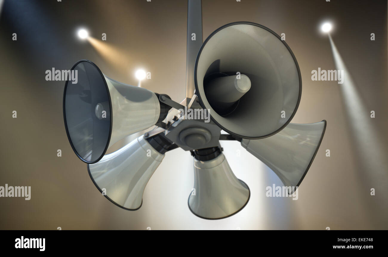 An array of five horn loudspeakers hanging off a pole in a circle