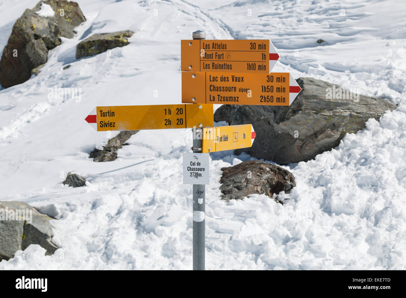 Signposts showing hiking route directions in the Swiss alps near Verbier in spring snow Stock Photo