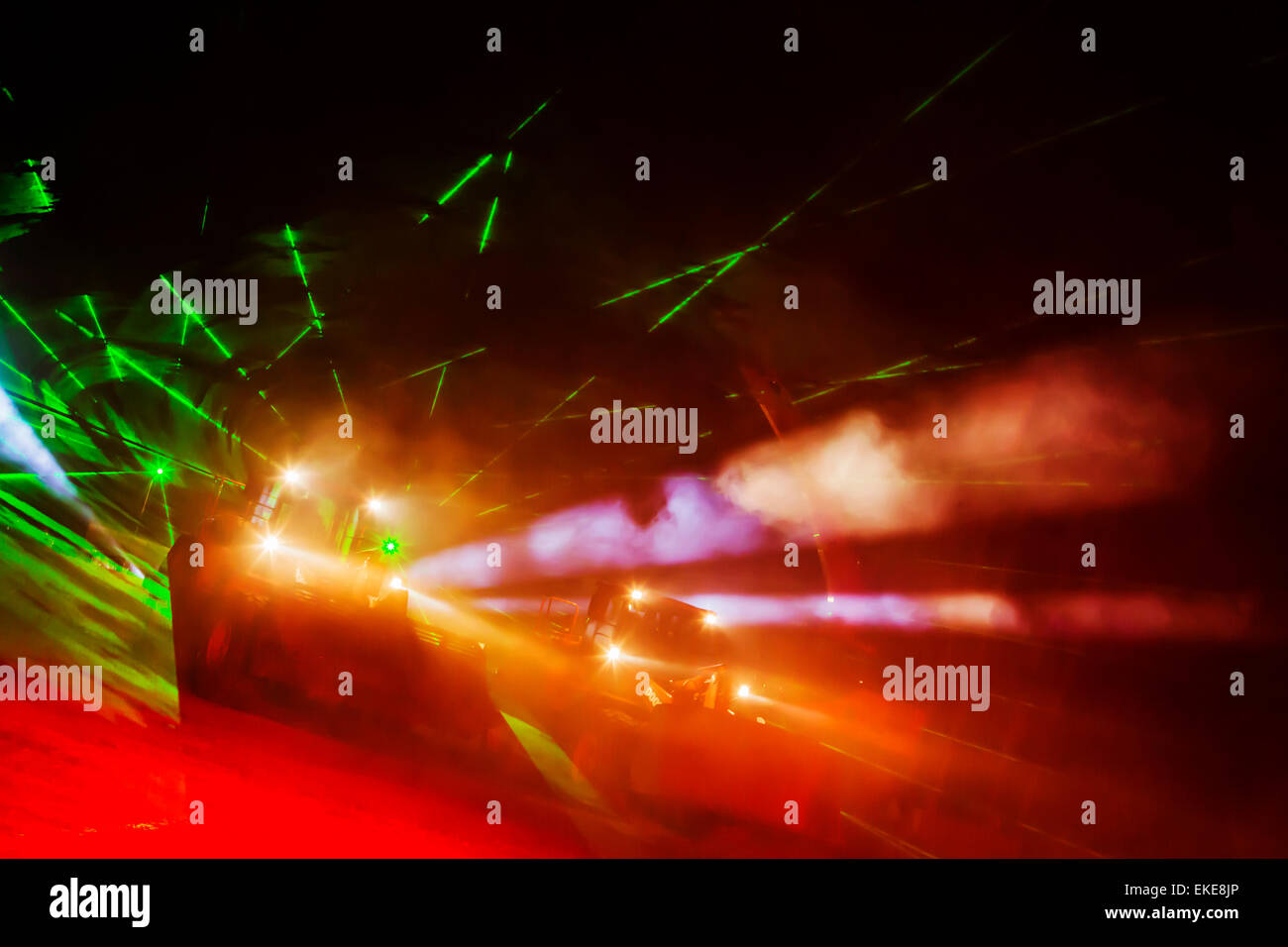. Color laser show with dancing diggers, Stock Photo