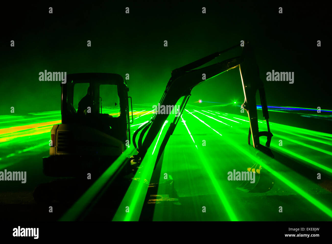 Color laser show with dancing diggers, Stock Photo
