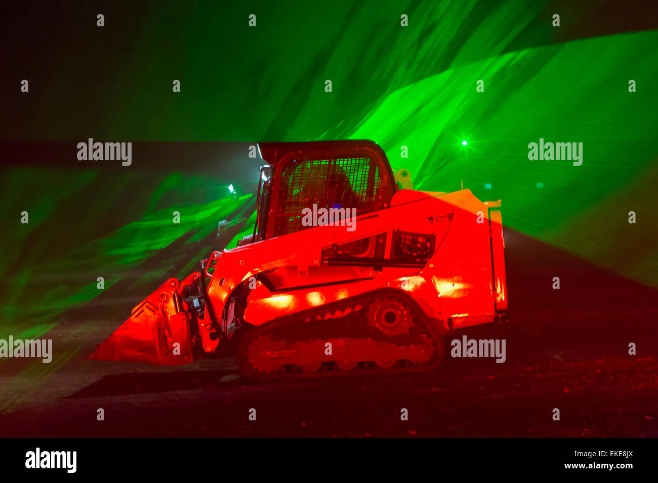 Color laser show with dancing diggers, Stock Photo