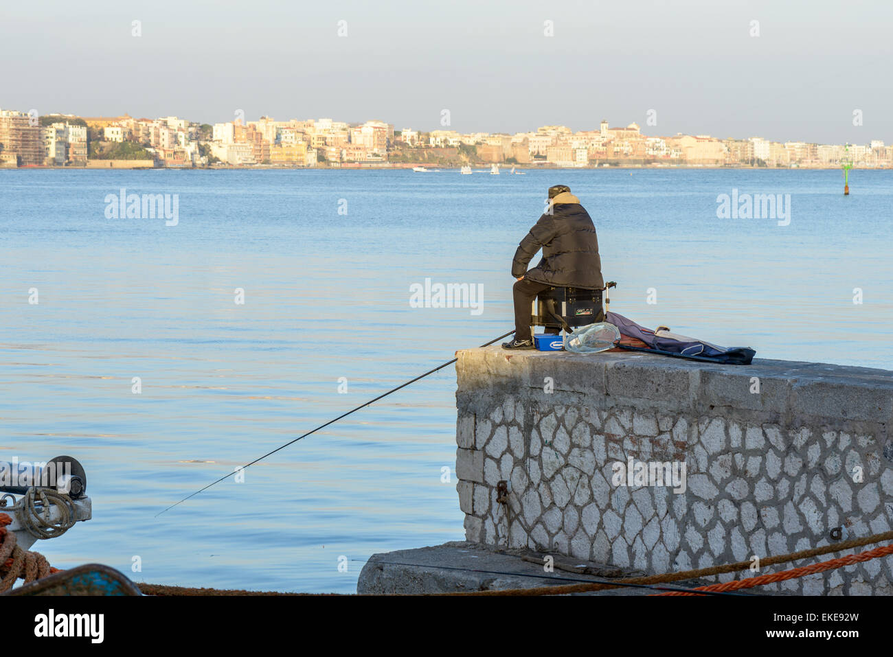 Man fishing in a winter day to seaport near rome italy Stock Photo