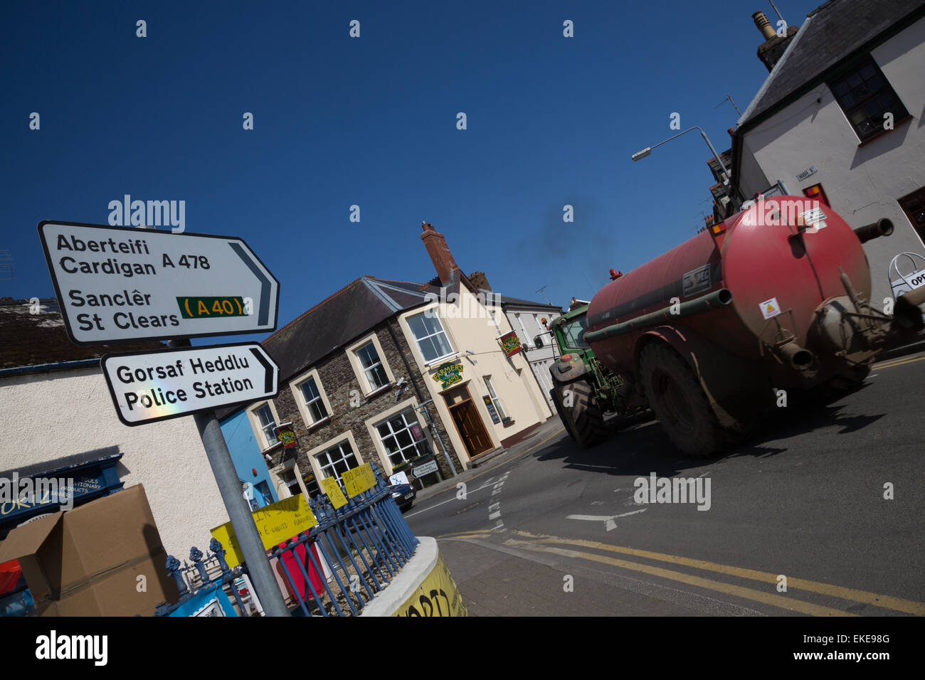 Road junction in the centre of Narberth, with tractor and muck spreader passing through Stock Photo
