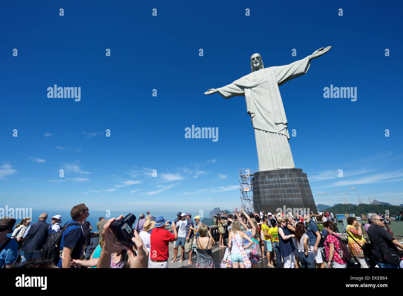 RIO DE JANEIRO, BRAZIL - MARCH 05, 2015: Groups of tourists pose for pictures on a bright morning at Christ the Redeemer. Stock Photo