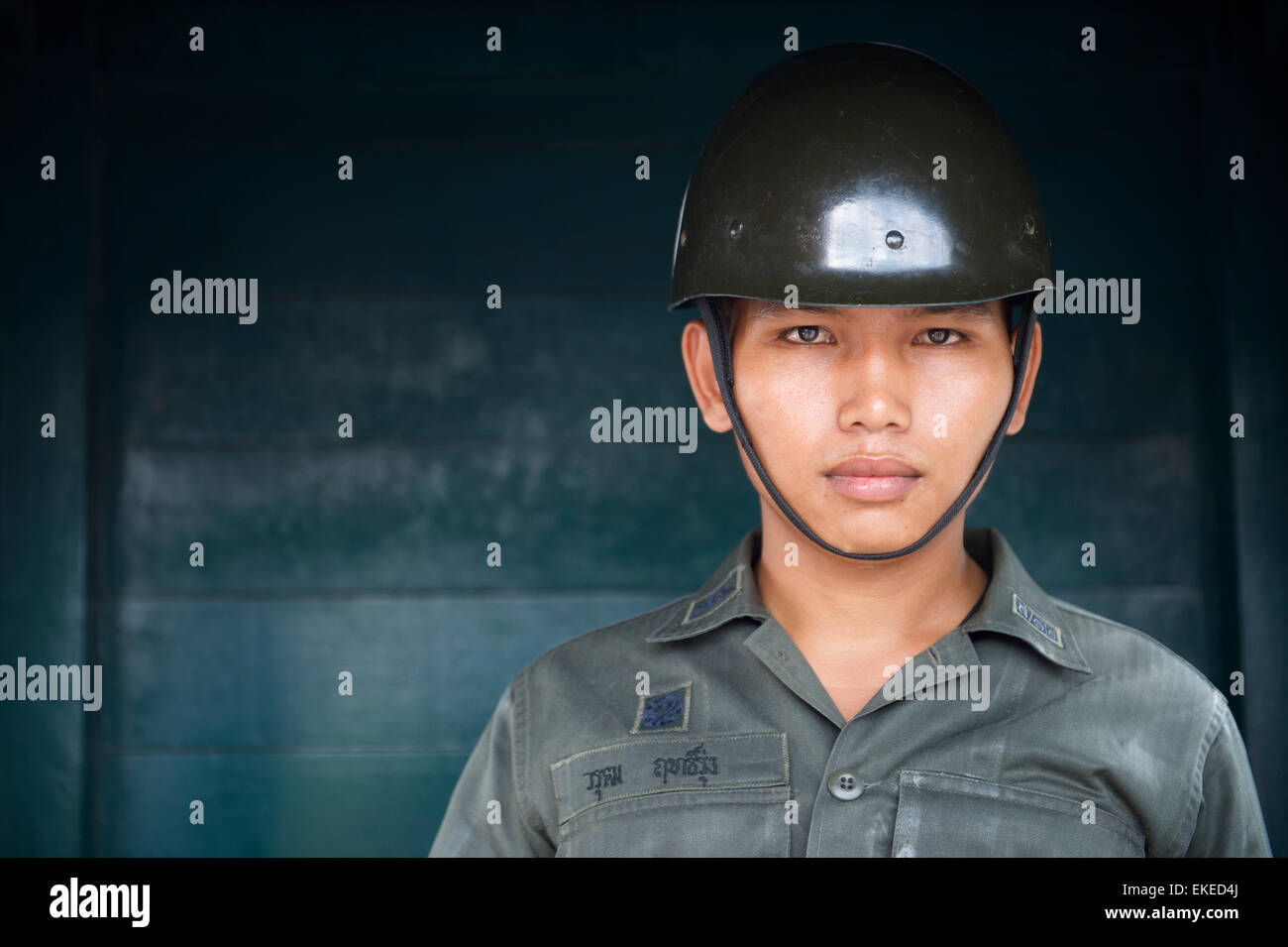 BANGKOK, THAILAND - OCTOBER 26, 2014: Young Thai Army soldier stands guard outside the Grand Palace. Stock Photo