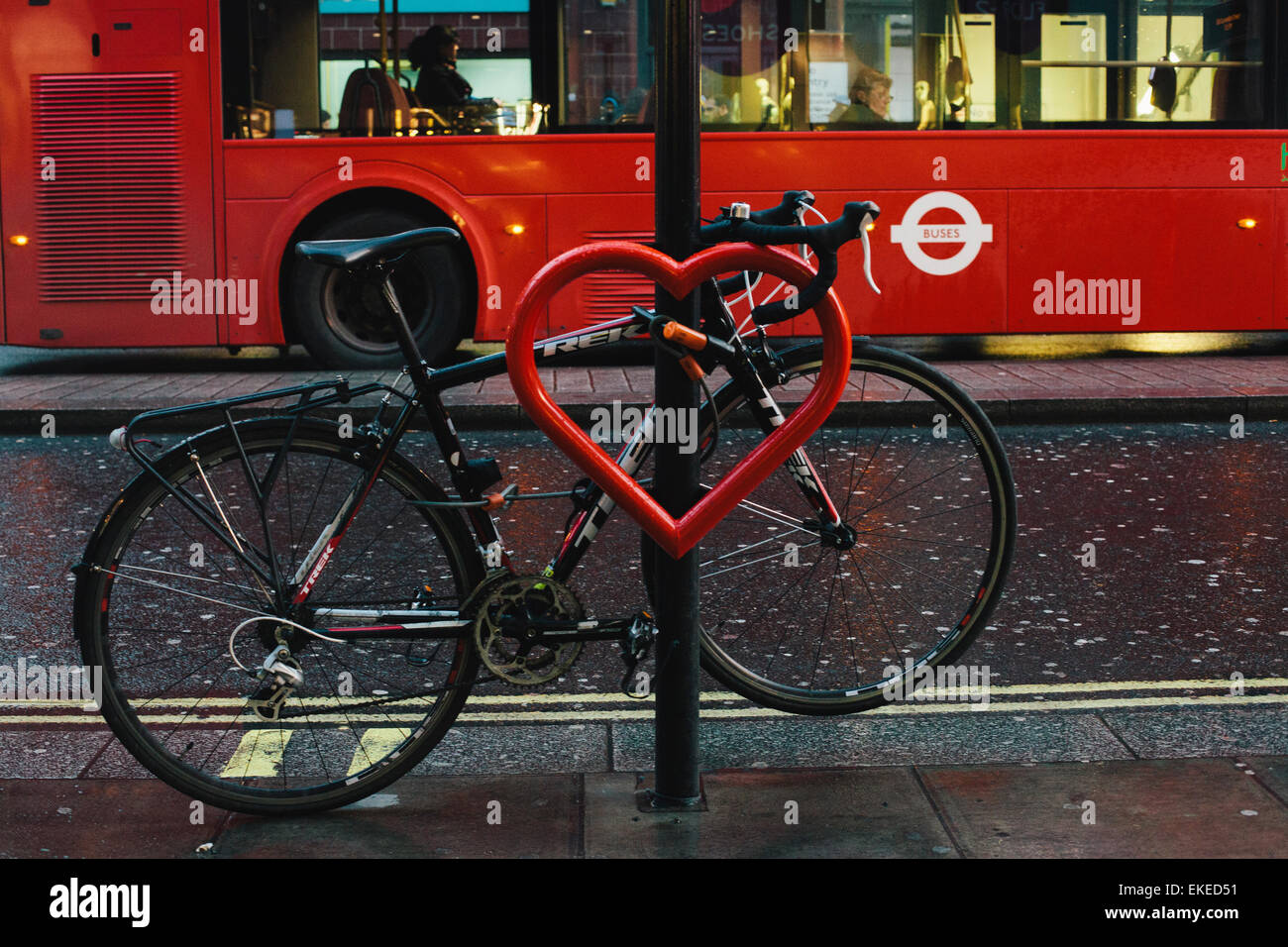 Red heart and a bike tied to a street lamp. Oxford street, London Stock Photo