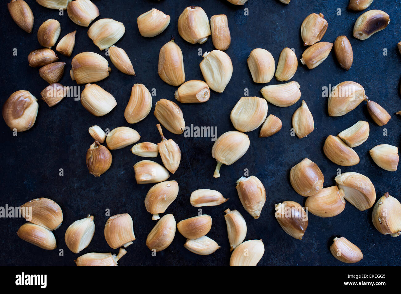 Baked garlic cloves in the oven top view Stock Photo Alamy