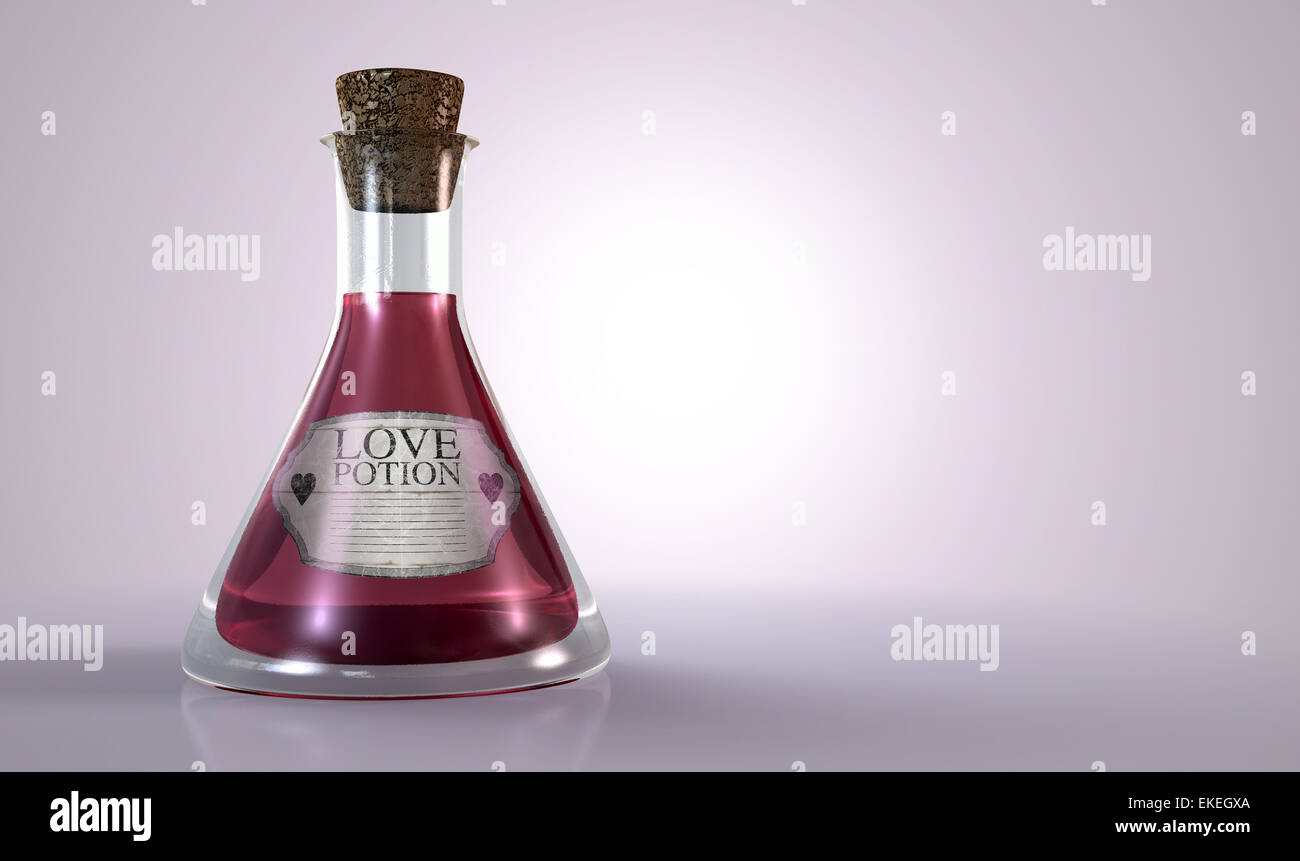 A regular old goblet glass bottle filled with a pink liquid with a label showing it is love potion and sealed with a cork on an Stock Photo