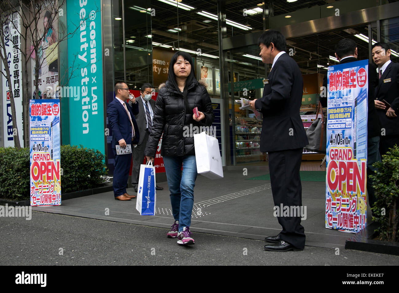 An Asian tourist holds her shopping at the new Yamada Denki (LABI