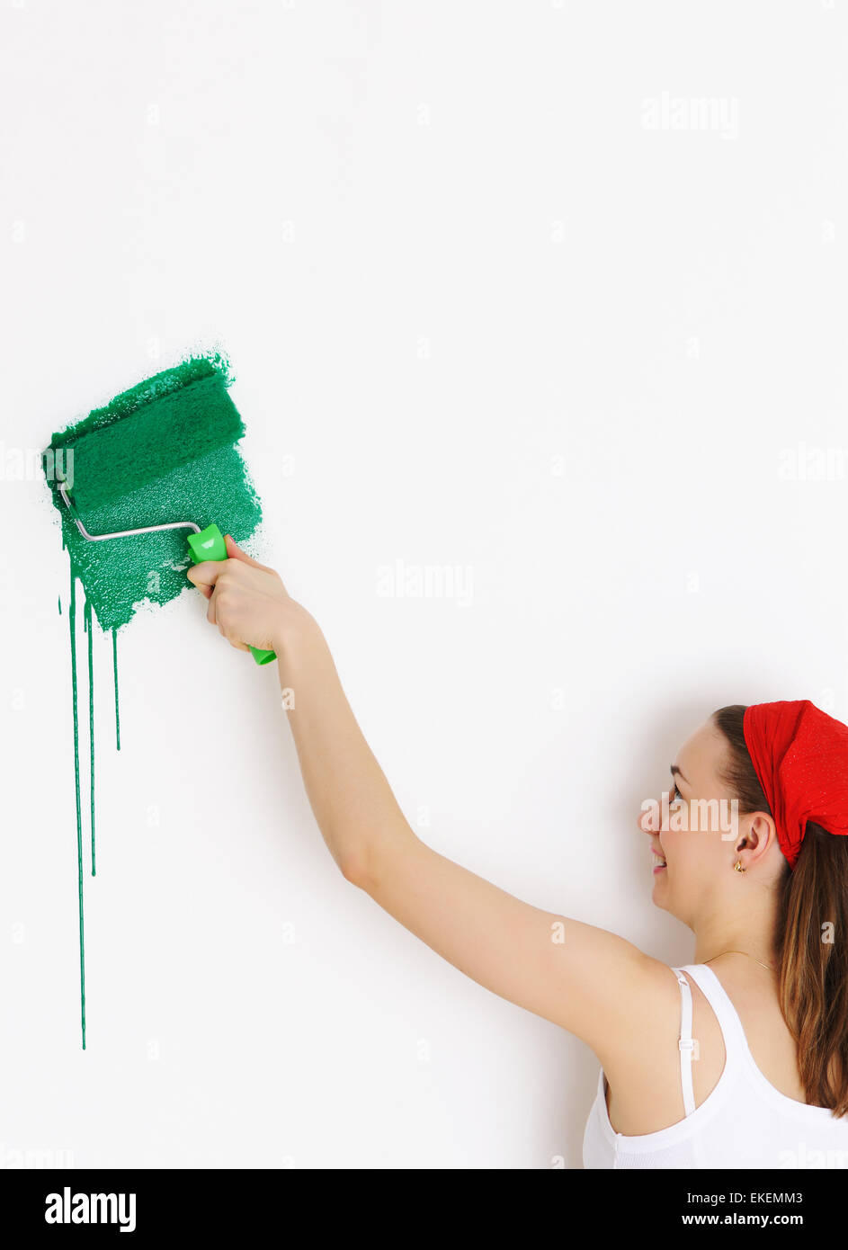 Девушка красит стену вид сзади