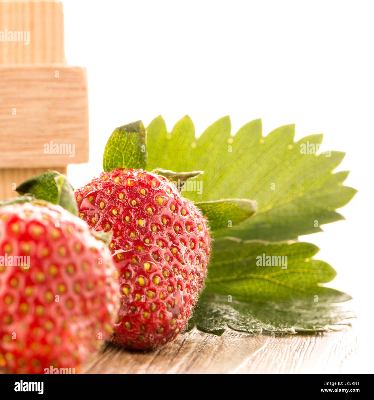 Strawberries over odl brown wooden table background Stock Photo - Alamy