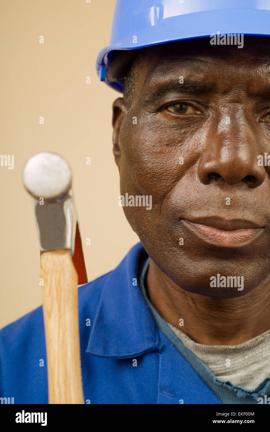 Construction worker holding hammer Stock Photo - Alamy