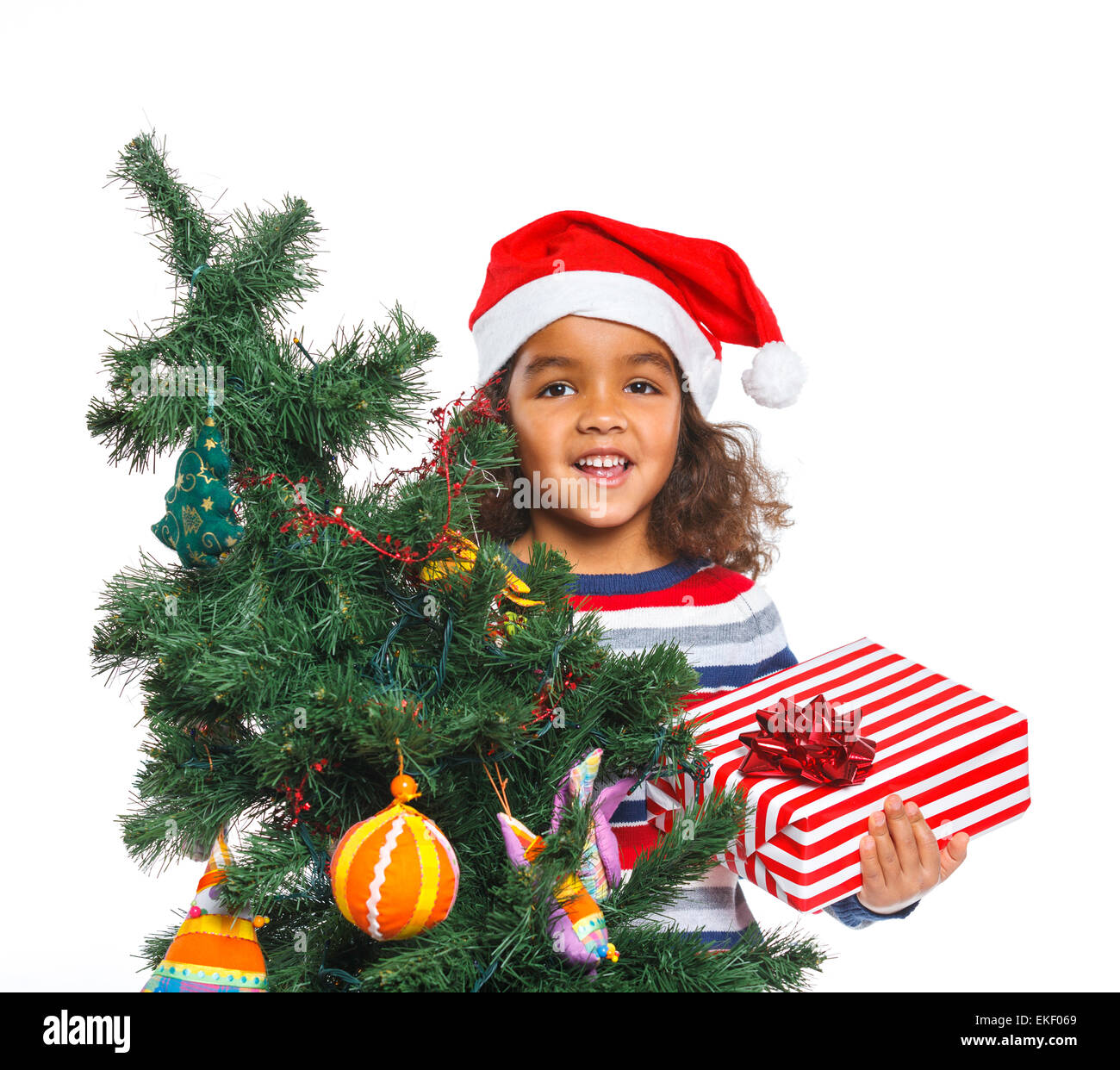 Little girl in Santa's hat with gift box Stock Photo