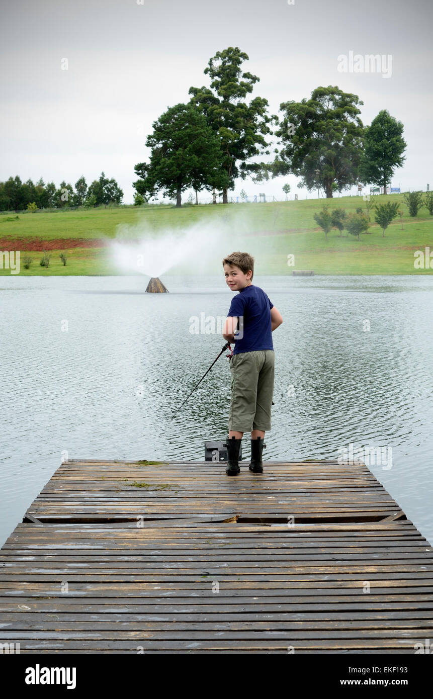 Boy bass fishing on dam or lake pier Stock Photo Alamy