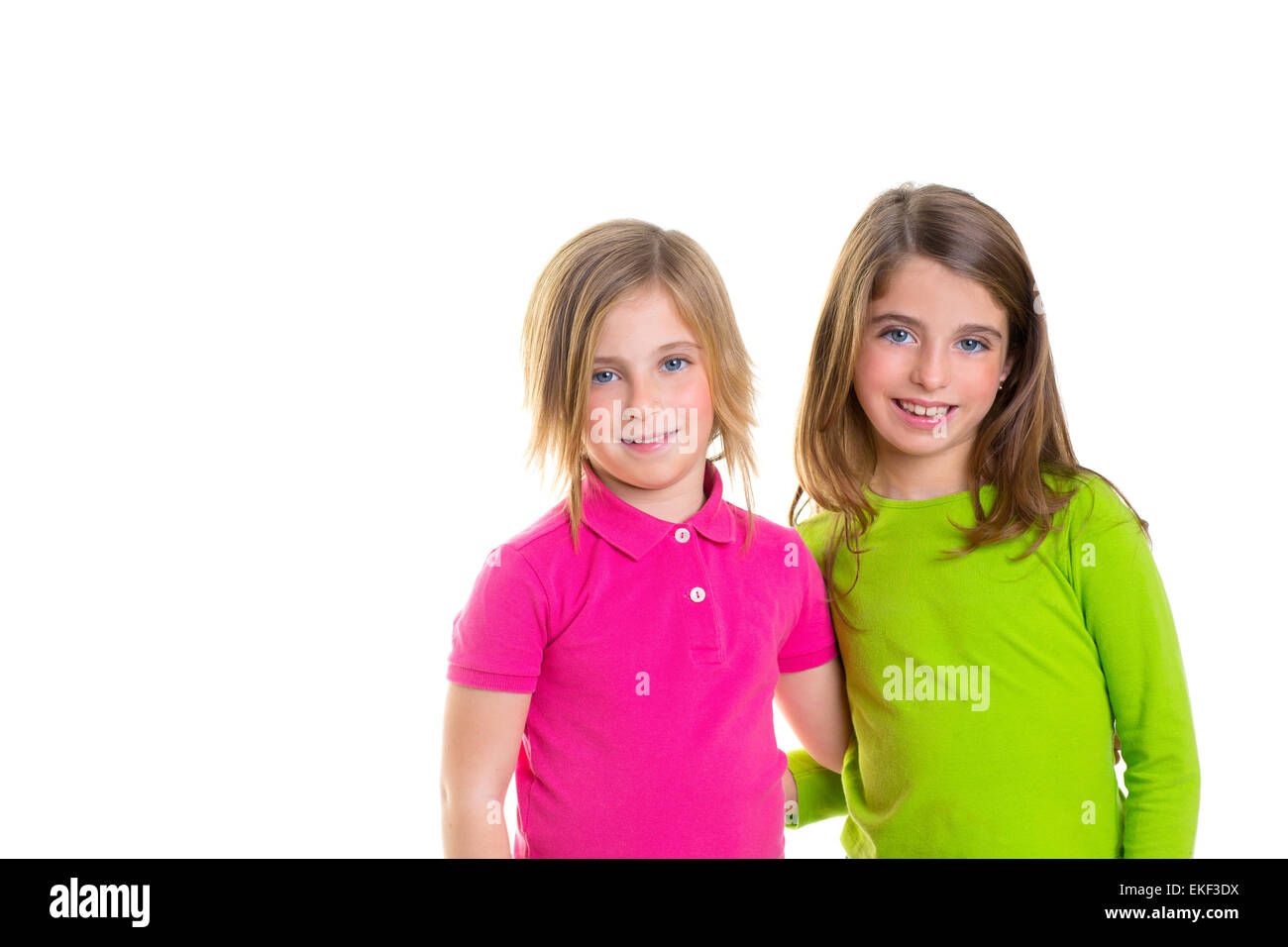 children happy two sister girls smiling hug together Stock Photo