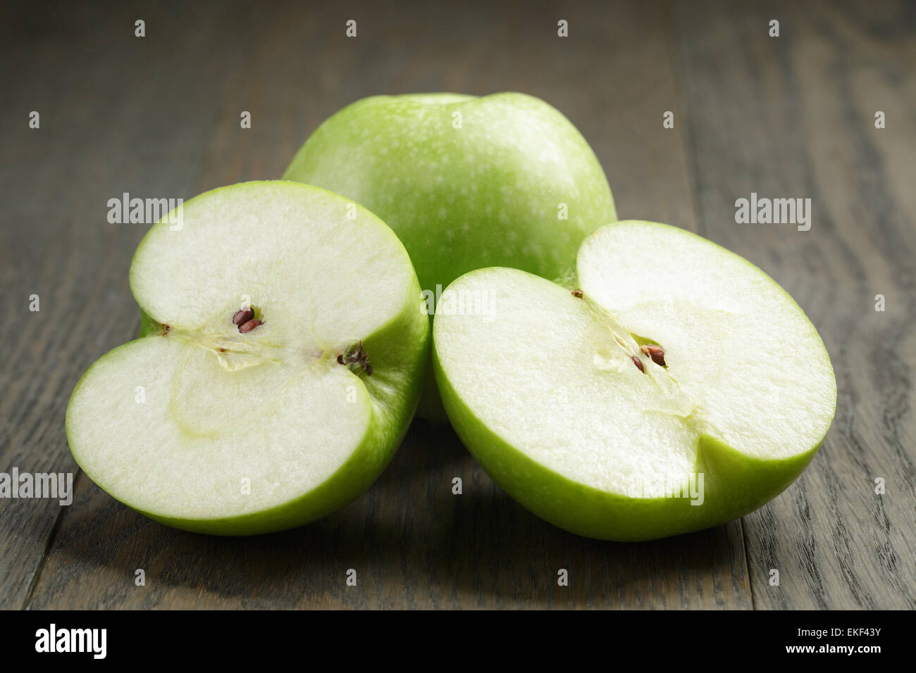 green sour apple on wood table sliced Stock Photo