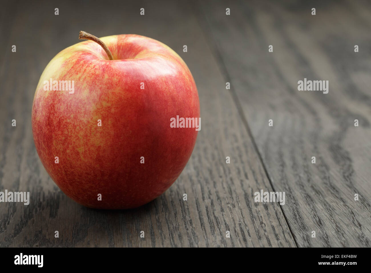 one red apple on wood table Stock Photo