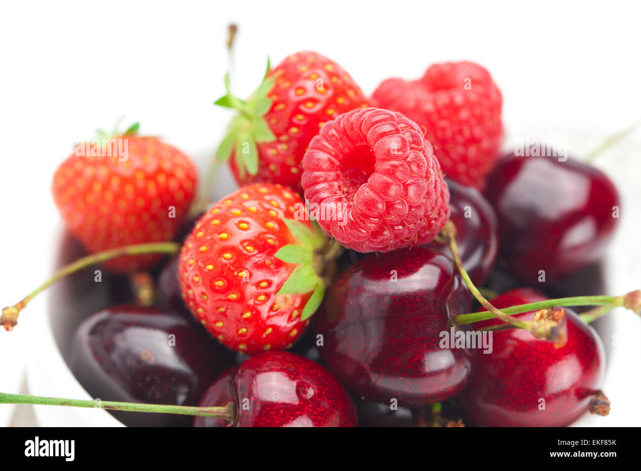 Cherry Vs Raspberry Size raspberries, strawberries and cherries in a bowl isolated on whi Stock ...