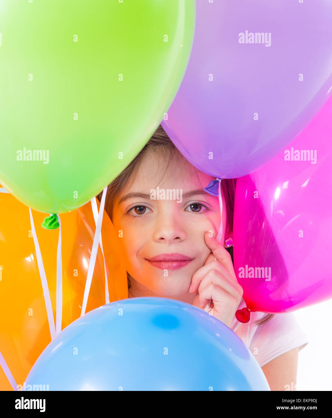 Happy child holding bunch of air balloons over white Stock Photo