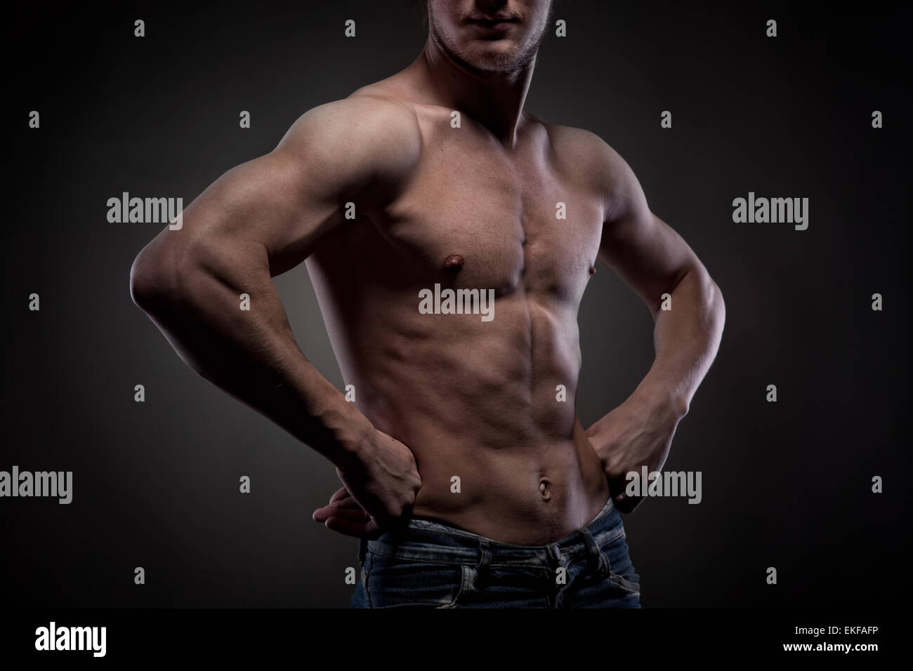 Muscular naked man on black Stock Photo - Alamy