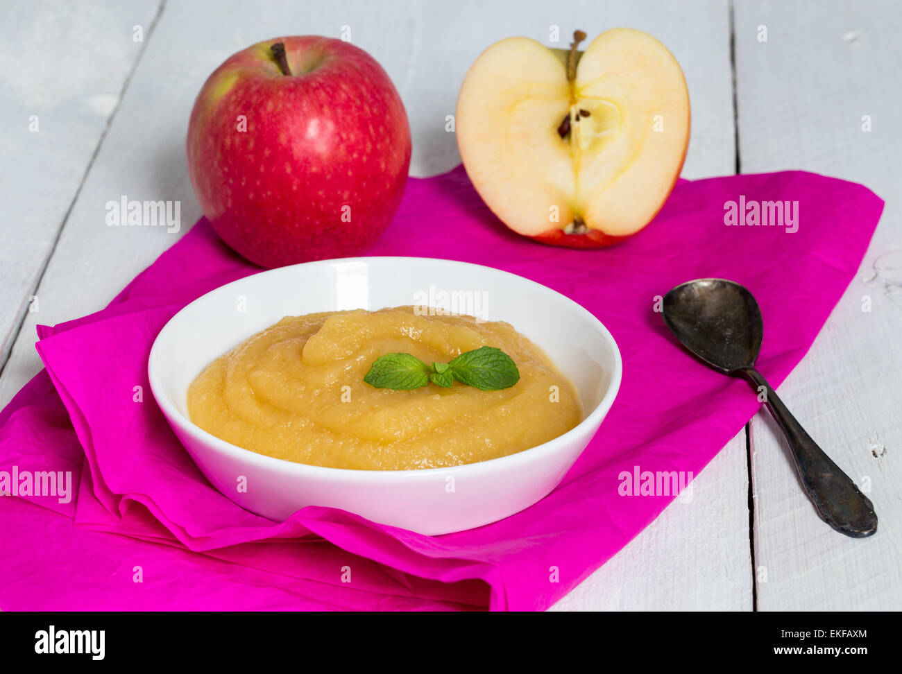Applesauce on pink paper and spoon Stock Photo Alamy