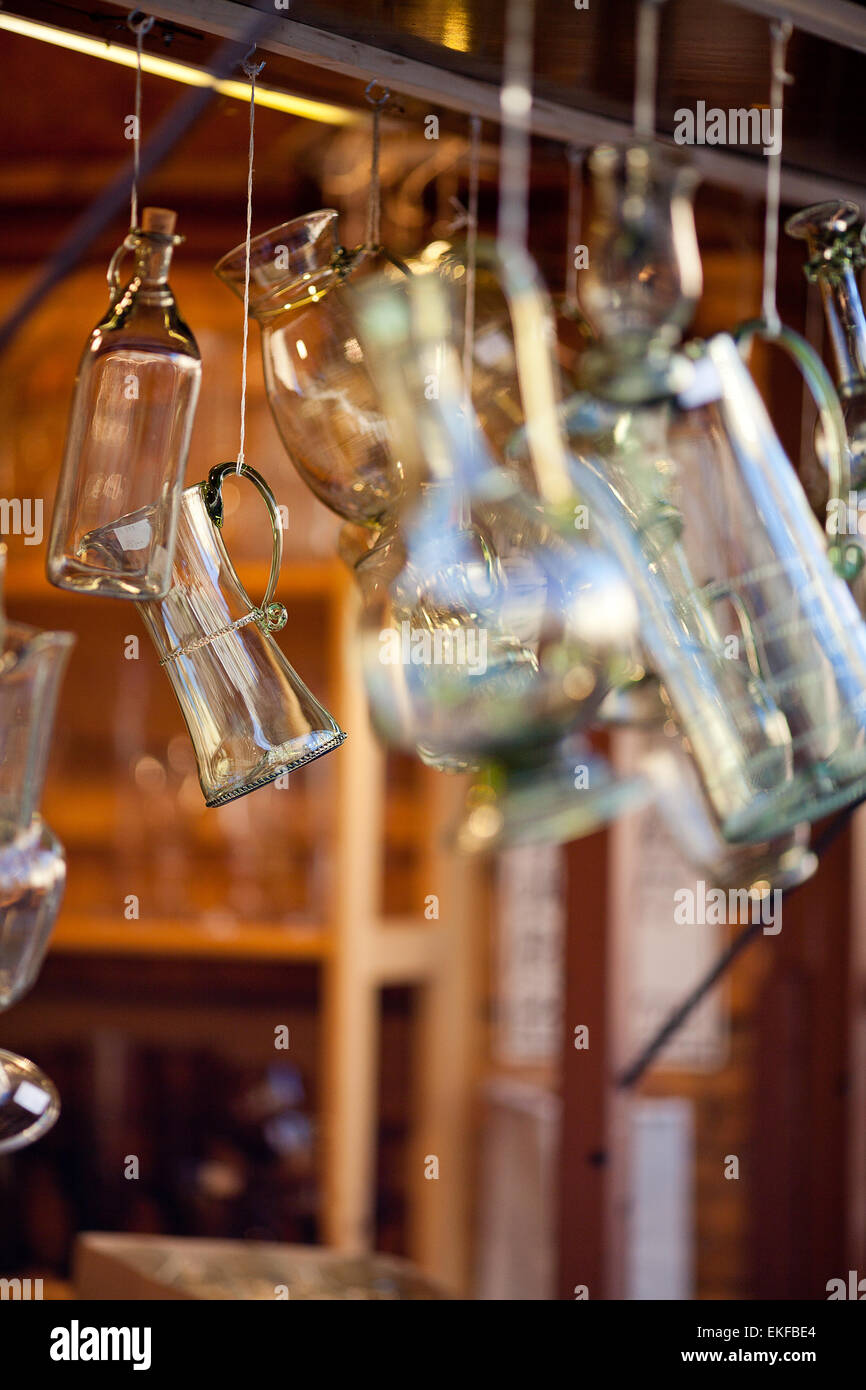 decanters of bohemian glass hanging on hooks Stock Photo