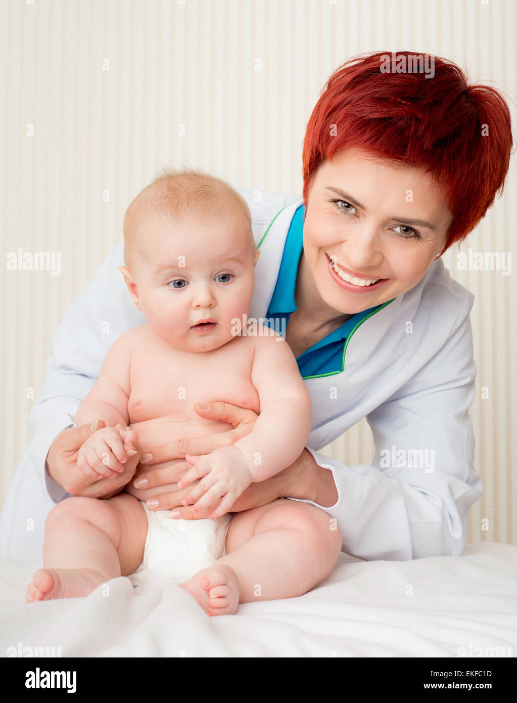 smiling doctor with small baby Stock Photo - Alamy