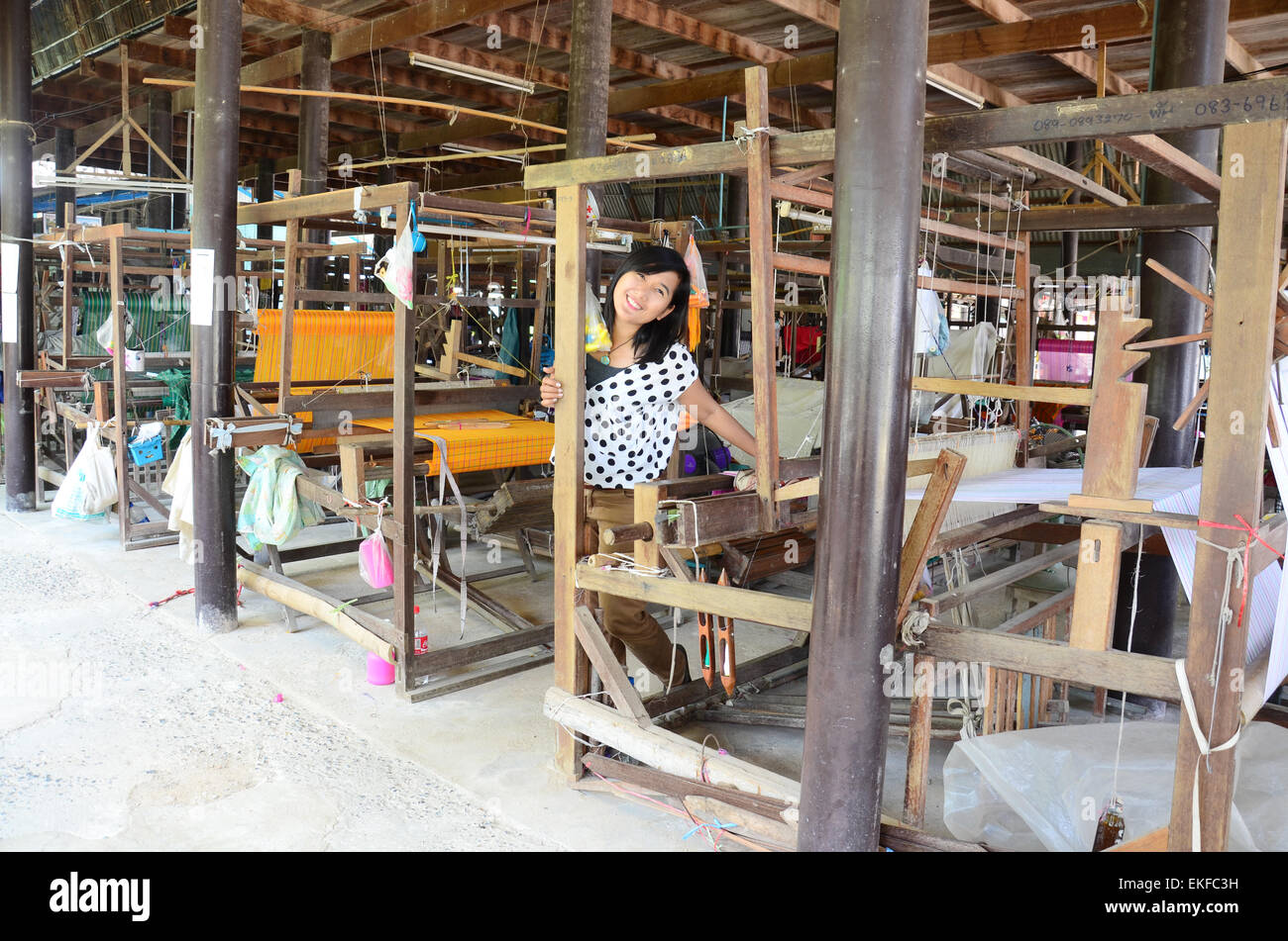 Thai woman portriat with Old Silk weaving Handicraft machine Tai Dam Style Stock Photo