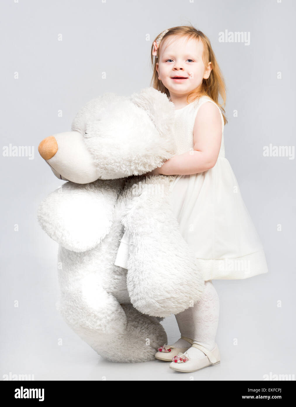 Little girl with toy bear Stock Photo